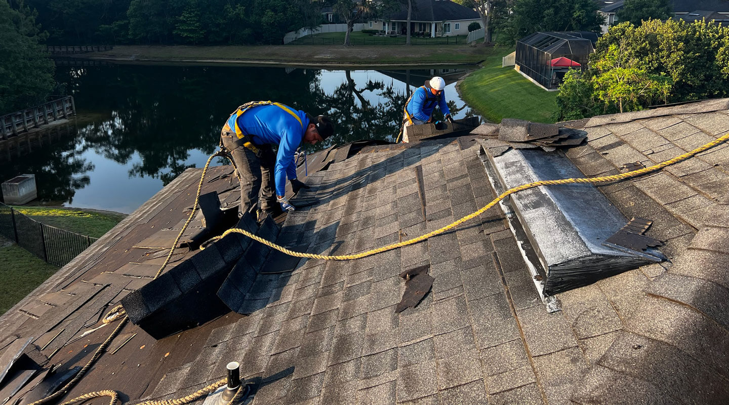 workers on top of residential home rooftop