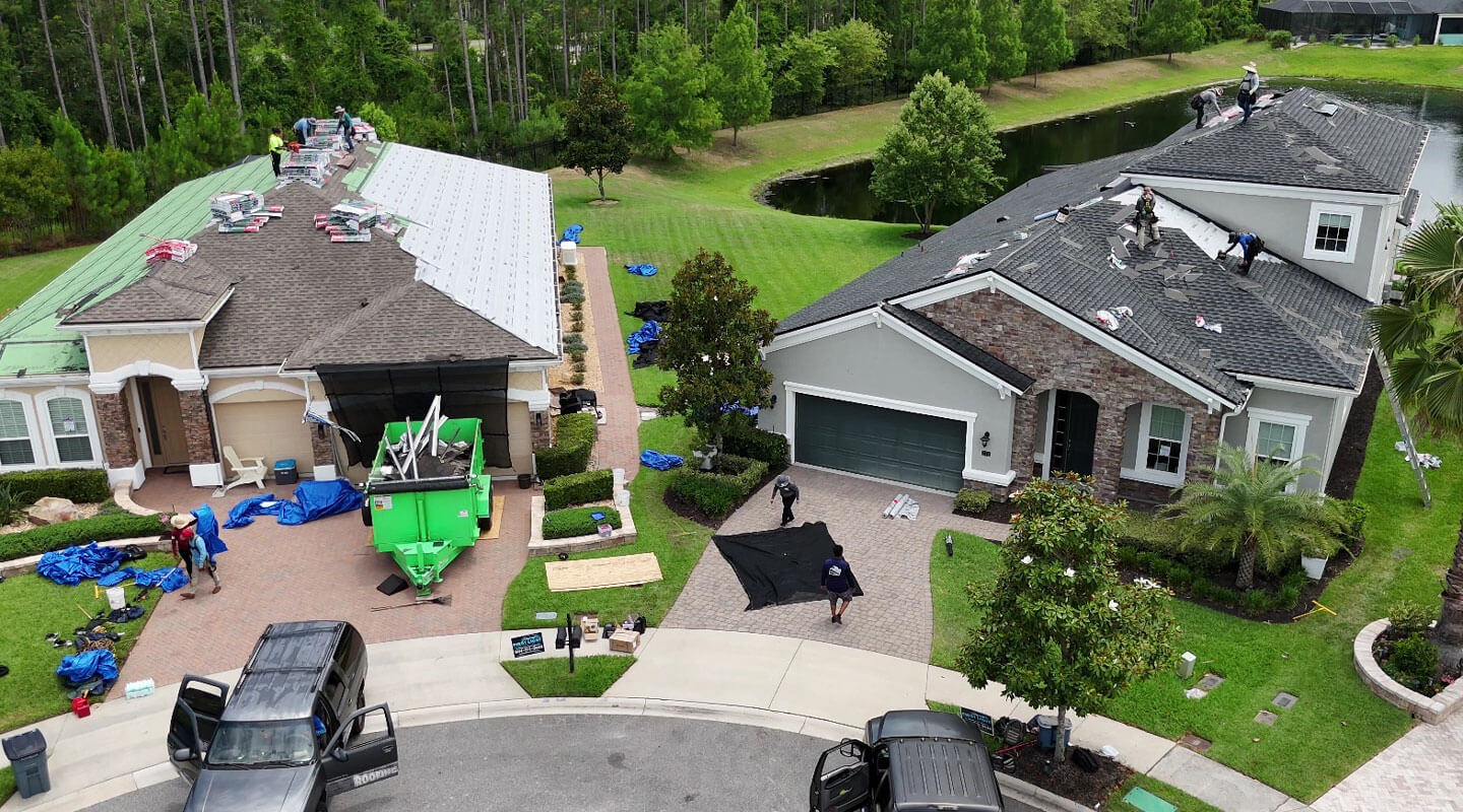 aerial view of two residential homes with roof repair